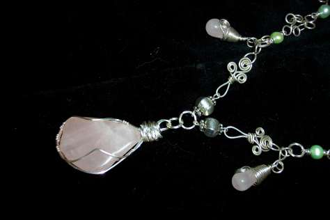 Detail of Large Caged Roase Quartz Nugget on Silver necklace