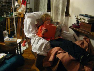 In Recliner, reading about artist, Alice Neel