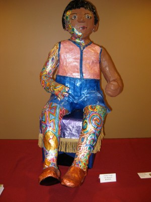 Trudy, papier mache child seated on paper mache hassock