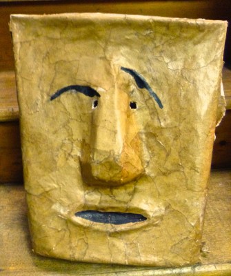Face Seen on Wastbasket and captured in a mask made of brown paper...