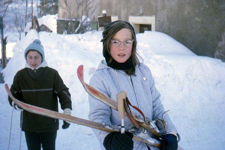 Carolyn Spiro with skis, probably early to mid 60s (not shoveling snow!)